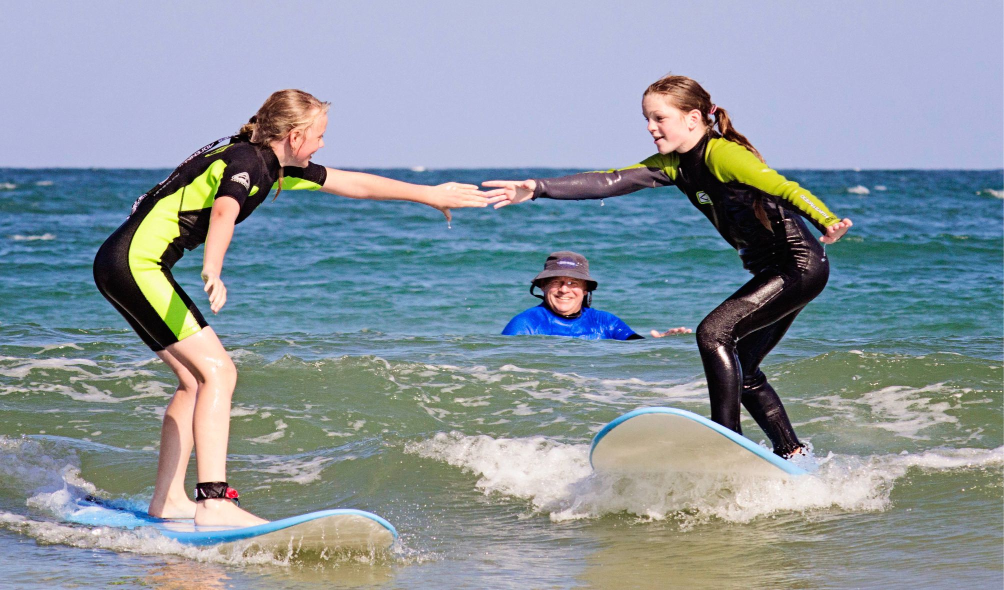 best friends surf together